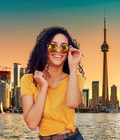 Women with sunglasses in front of city